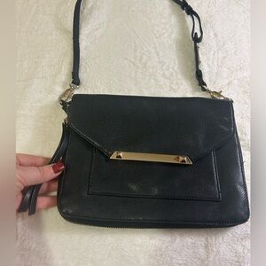 Settle and dot cross body clutch bag with gold accents. Like new